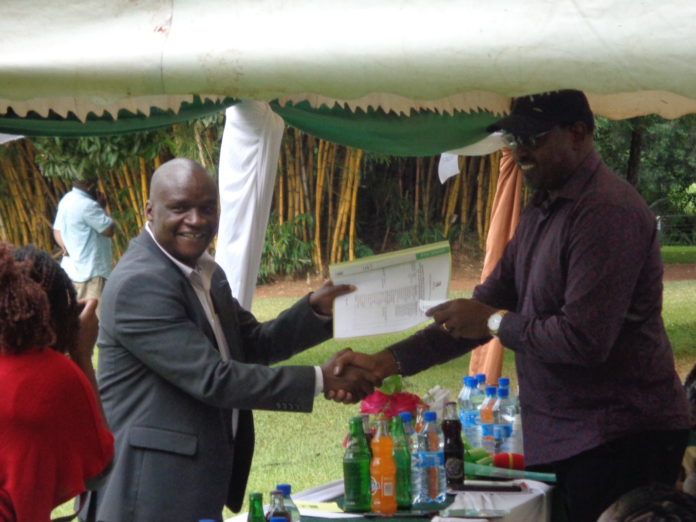 Sonysugar Board chair Hon. Jared Kopiyo presenting a memorandum document to Agriculture and Livestock committee chair Hon. John Mutunga.