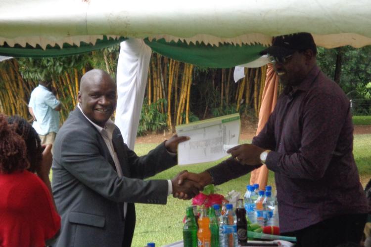 Sonysugar Board chair Hon. Jared Kopiyo presenting a memorandum document to Agriculture and Livestock committee chair Hon. John Mutunga.